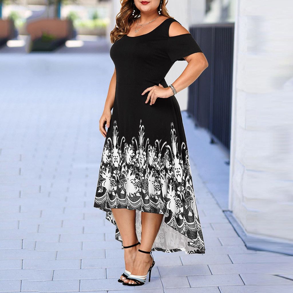 Side view on a model: Bring some serious style to your wardrobe with our Women's Plus Size High-Low Midi Dress. The elaborate design at the base gives this dress a unique touch, while the round neckline and cut out at shoulders add to its chic and playful vibe. Perfect for any occasion, this dress will become your new favorite go-to!